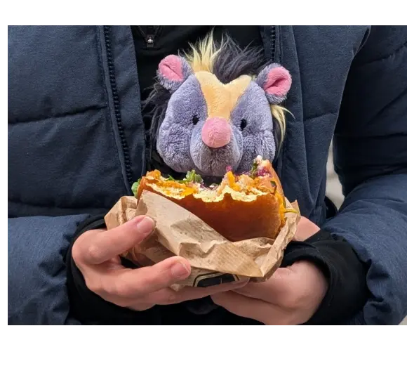 Mini Christopher eating a burger